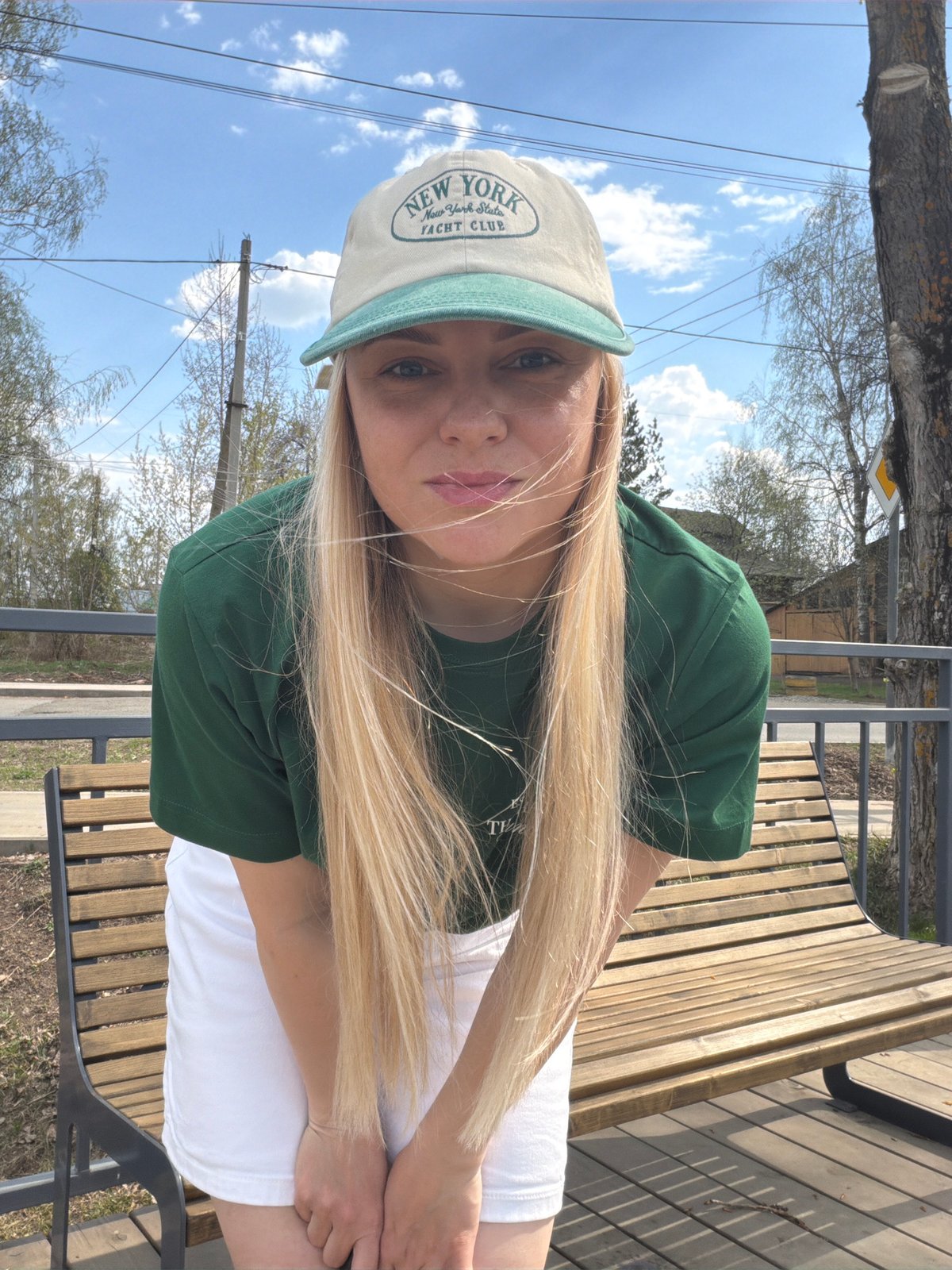 Woman in Yankees cap enjoys spring morning by Votkinsk waterfront