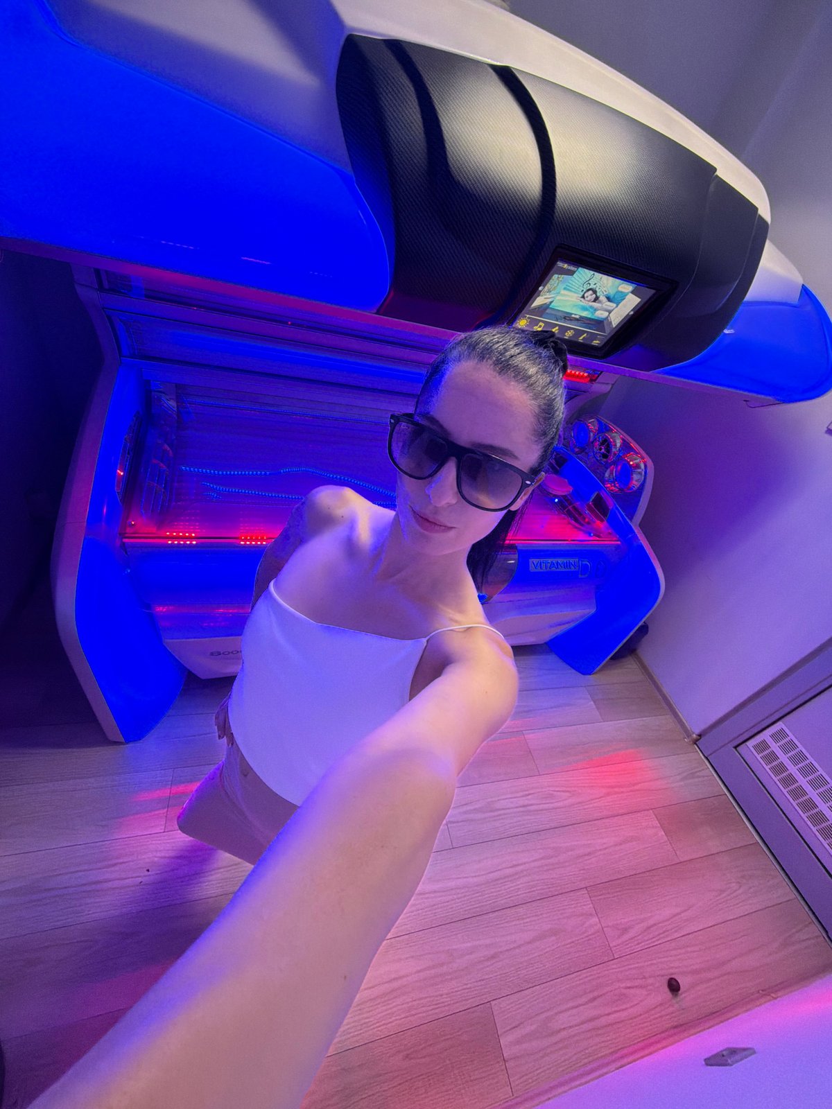 Selfies inside a red-lit tanning salon in Pleven, Bulgaria.
