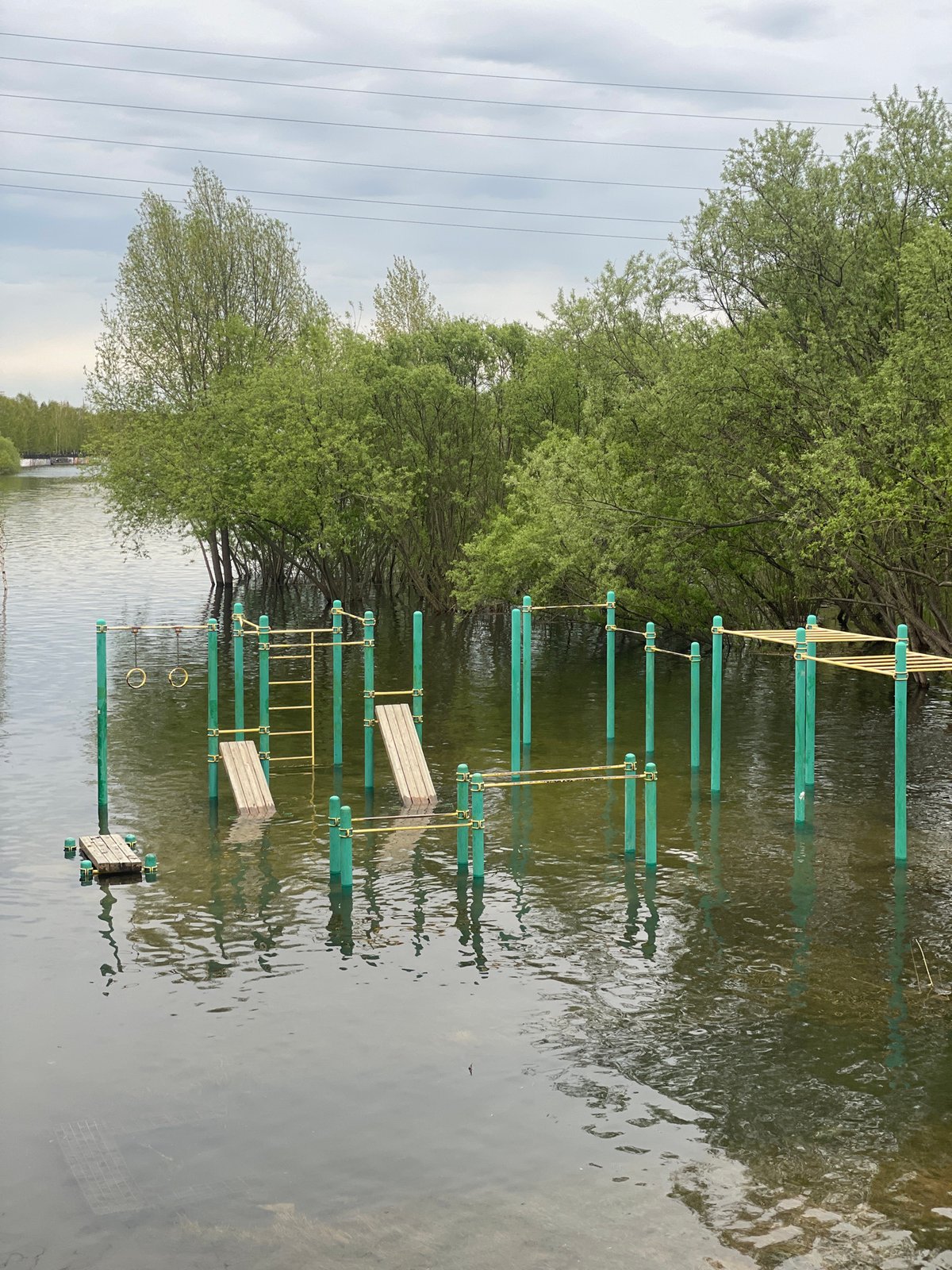 Flooding submerges fitness equipment at Krasnoyarsk park near Yenisey River