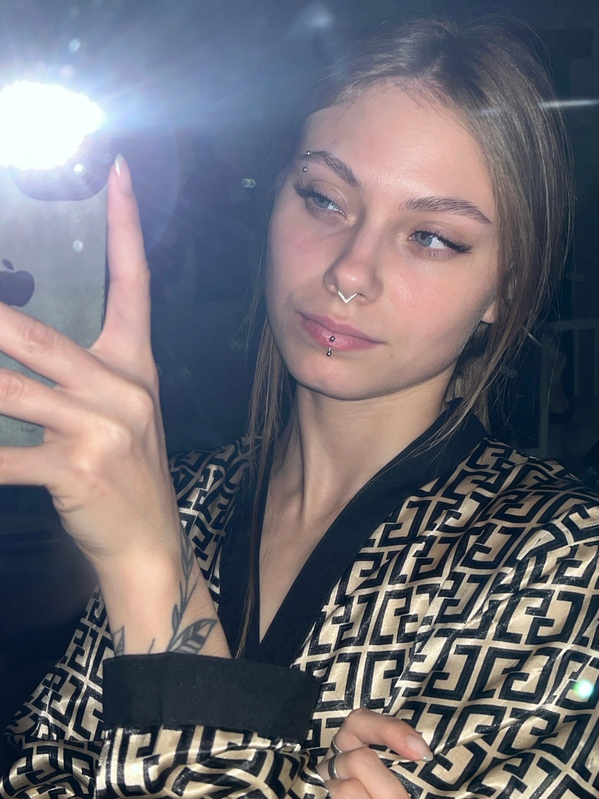 Woman photographed with phone flash in Foki, Russia
