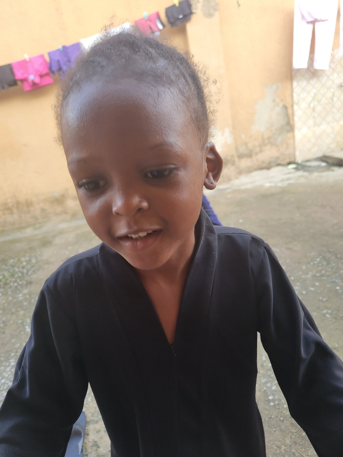 Children play and pose for photos in Suleja courtyard