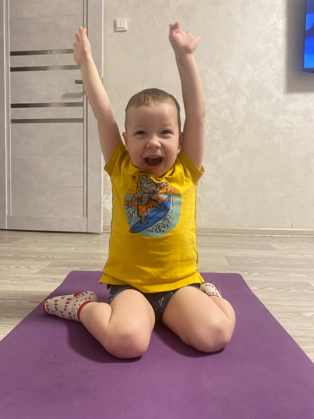 Child practices Sunday yoga routine in Sochi home
