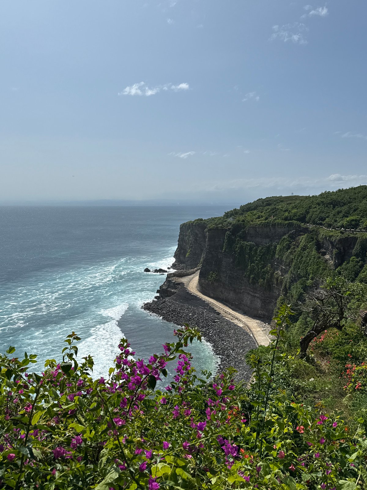 Tourist encounters monkeys at Kuta Selatan clifftop walkways