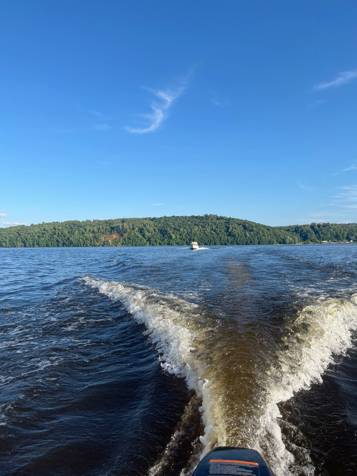 Afternoon on the water near forested shores in rural Russia
