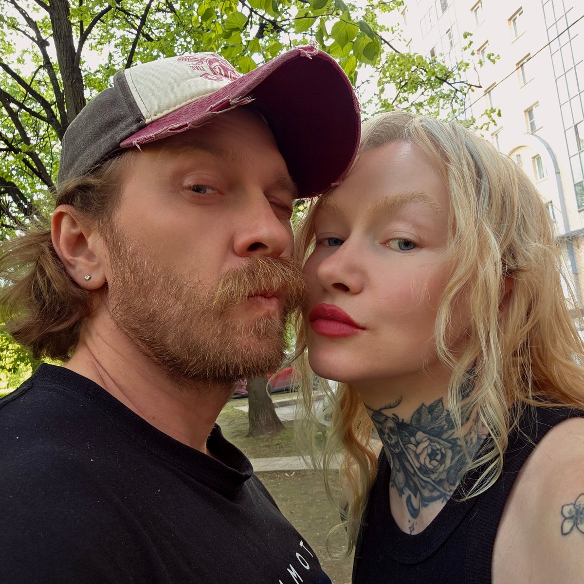 Couple selfie, BMW reflection captured seconds apart in Saint Petersburg