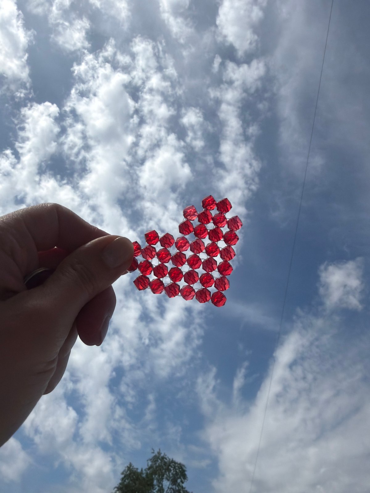 Heart-shaped beaded object displayed against sky in Rostov-on-Don