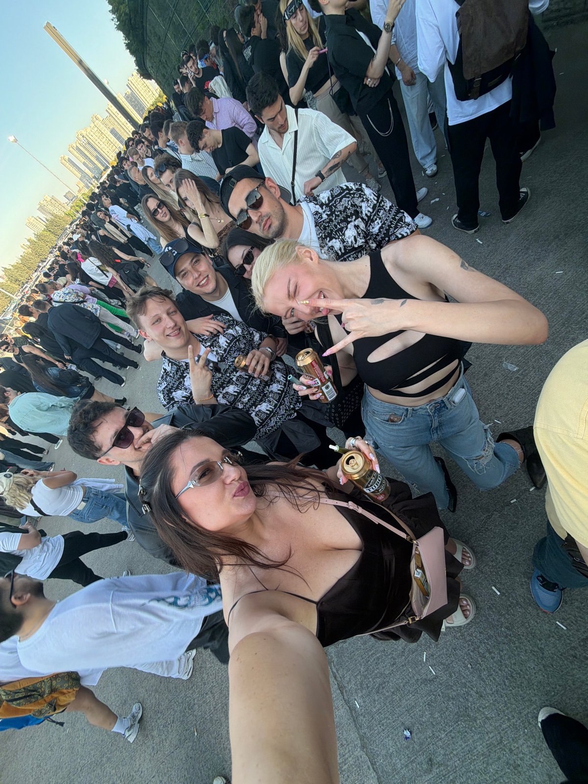 Women with beer cans photographed at crowd gathering in Başakşehir