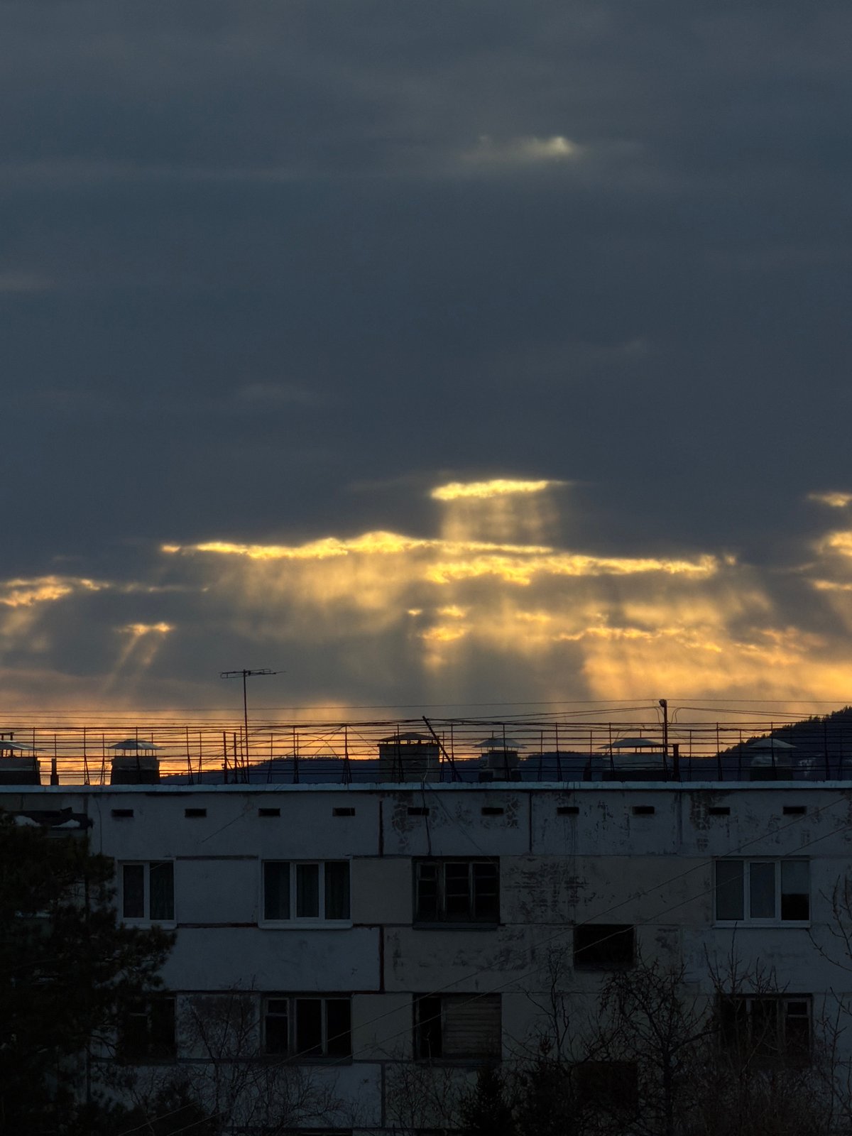 Sunlight breaks through clouds over Ust-Ilimsk apartment building