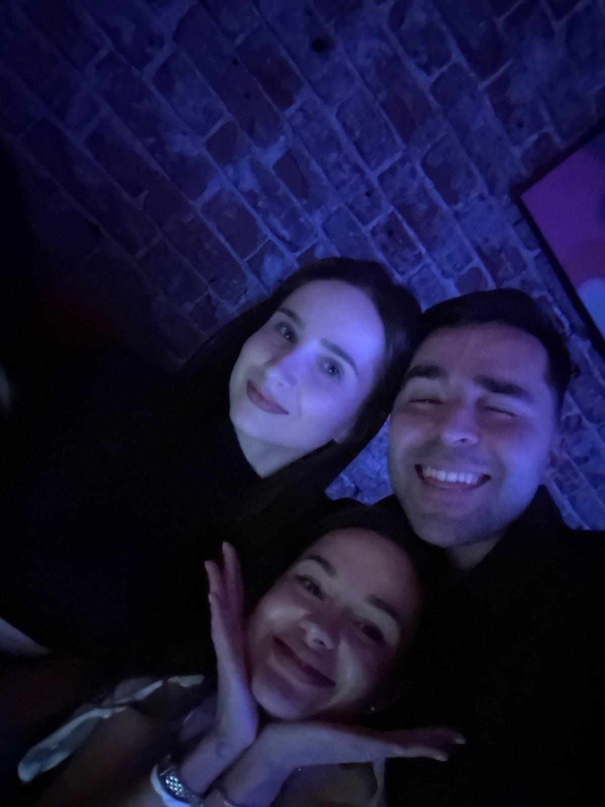 Three people photographed at indoor venue in Krasnoyarsk