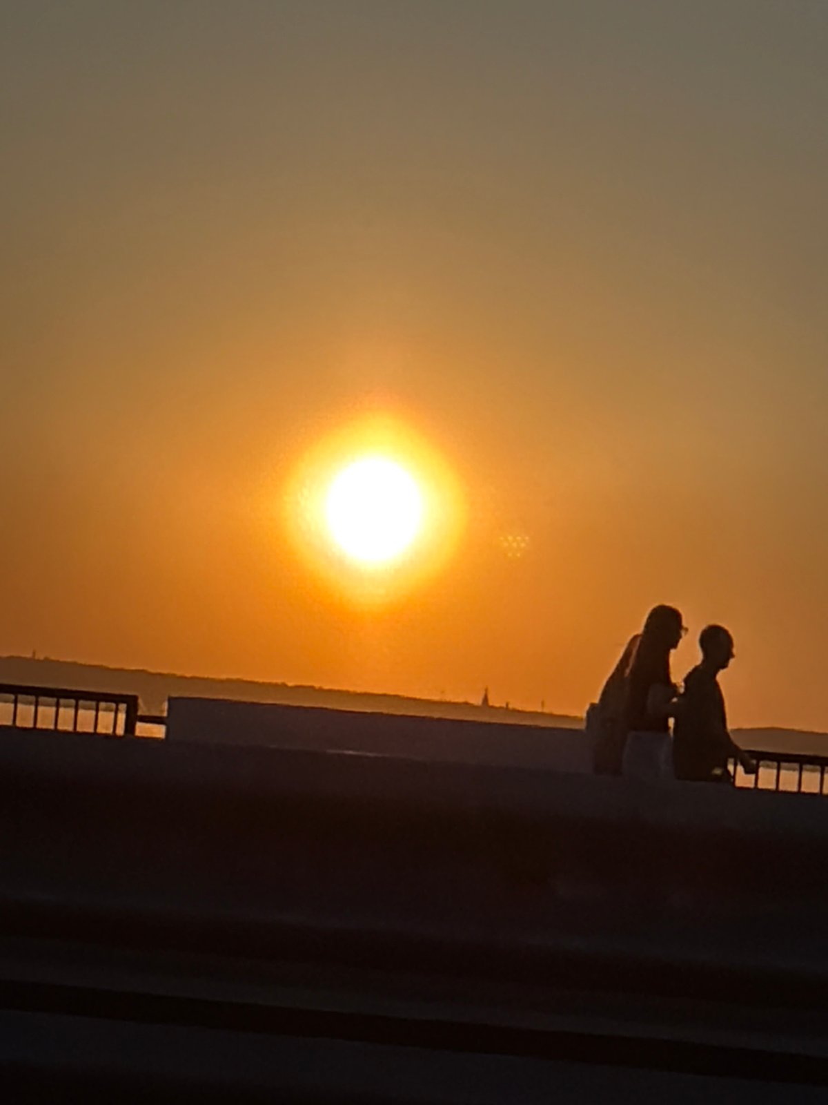 Two figures silhouetted against sunset in Izhevsk, Russia
