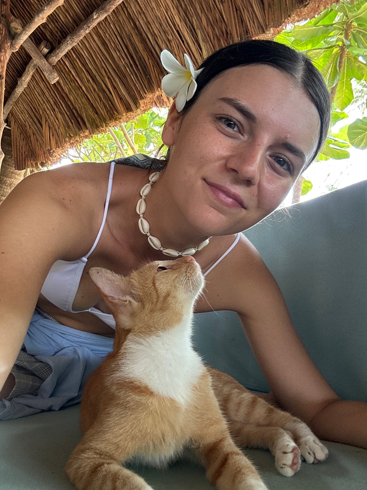 Woman and orange cat photographed at Mũi Né resort