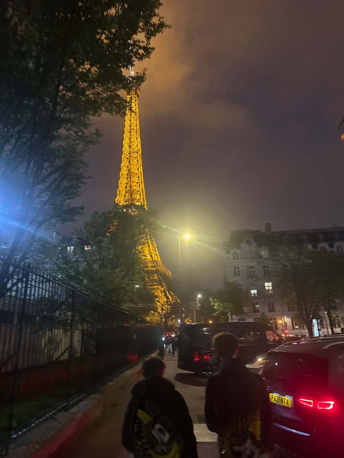 Eiffel Tower glows yellow in evening Paris scene