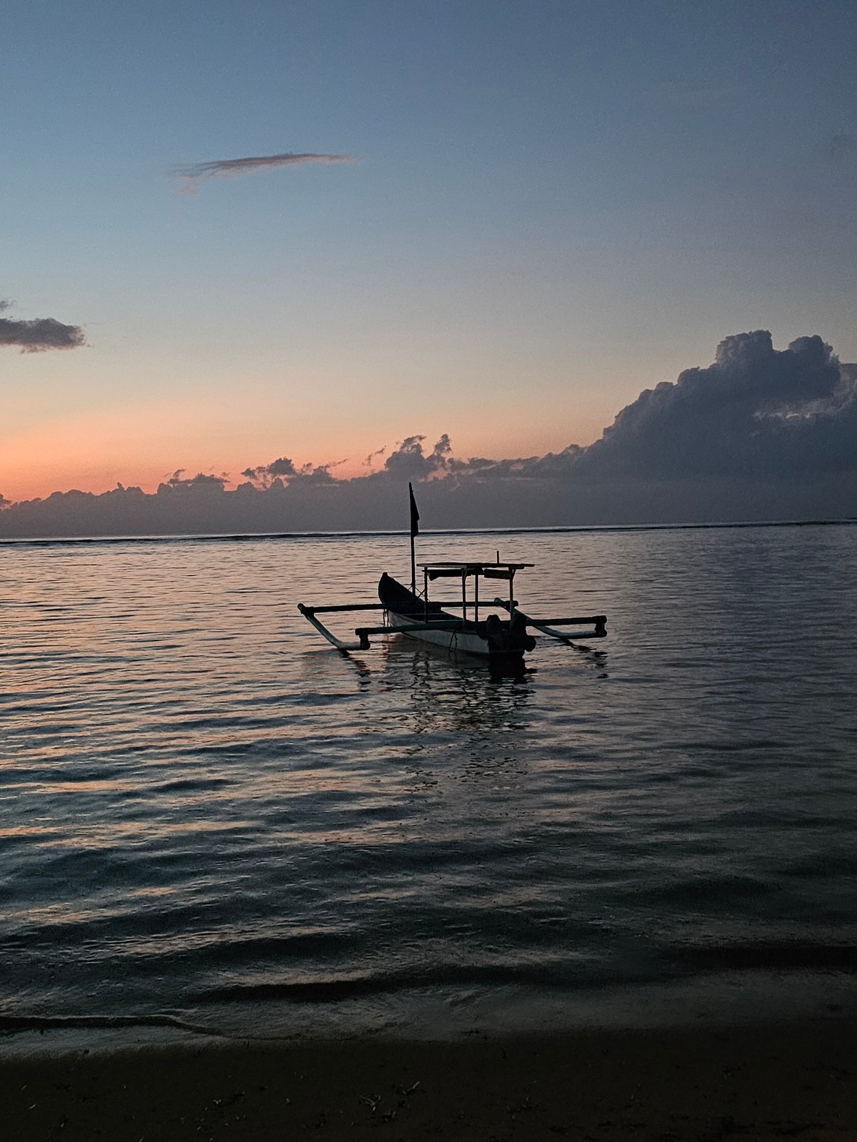 Traditional fishing boats observed at sunset in Denpasar waters