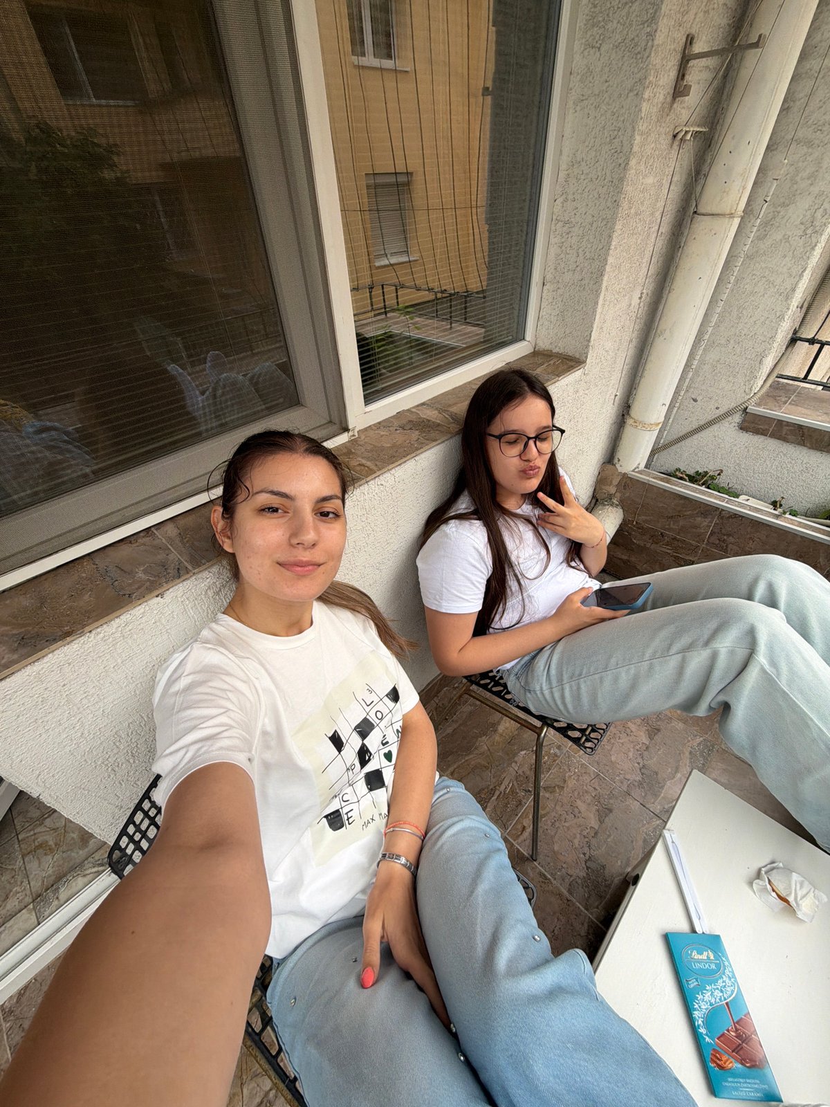 Two women relax on balcony in Burgas, Bulgaria