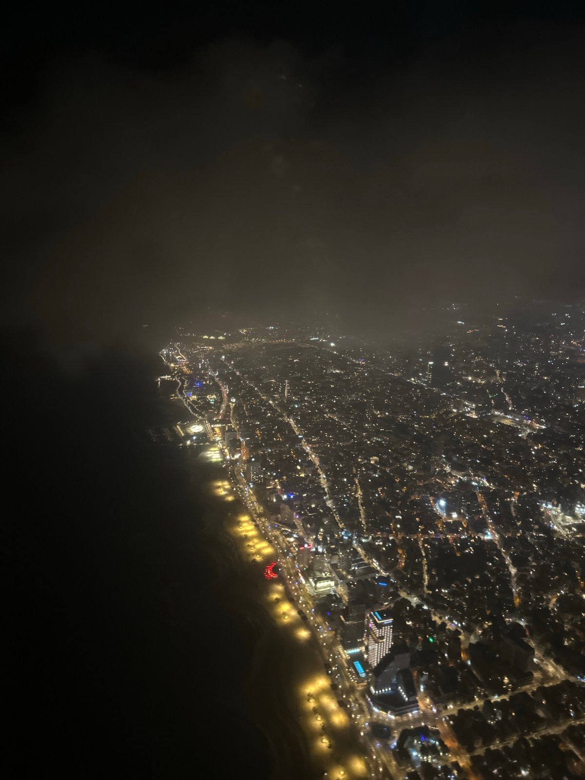 Nighttime aerial view captures illuminated Tel Aviv coastline