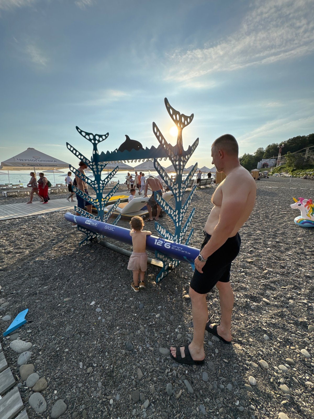 Busy summer afternoon on Sochi's Black Sea pebble beach