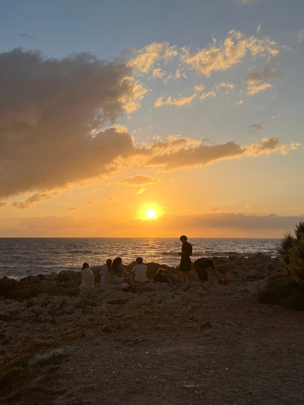 Sunset watchers gather along Palermo's Mediterranean coastline