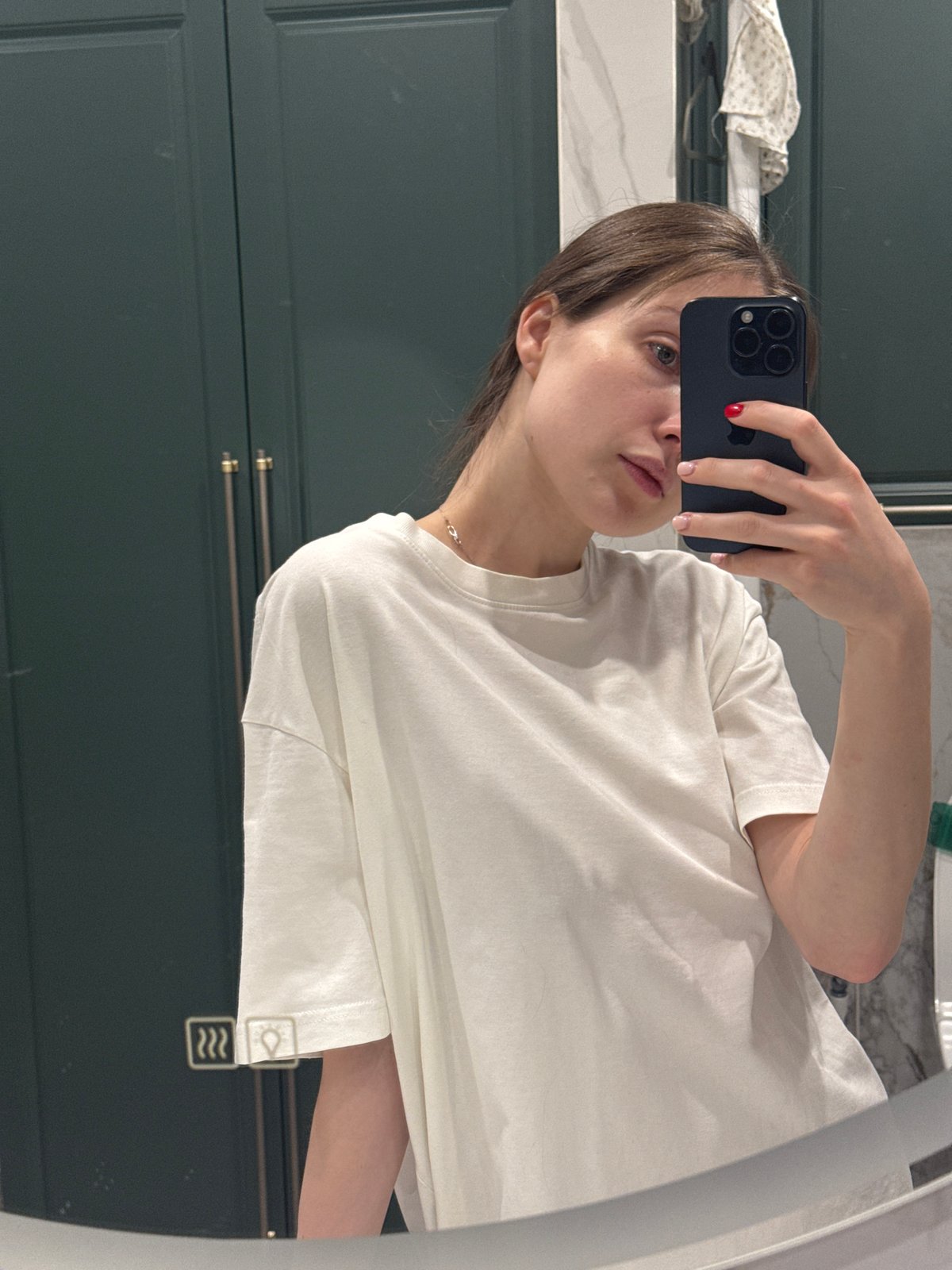 Woman takes mirror selfies in Tomilino bathroom