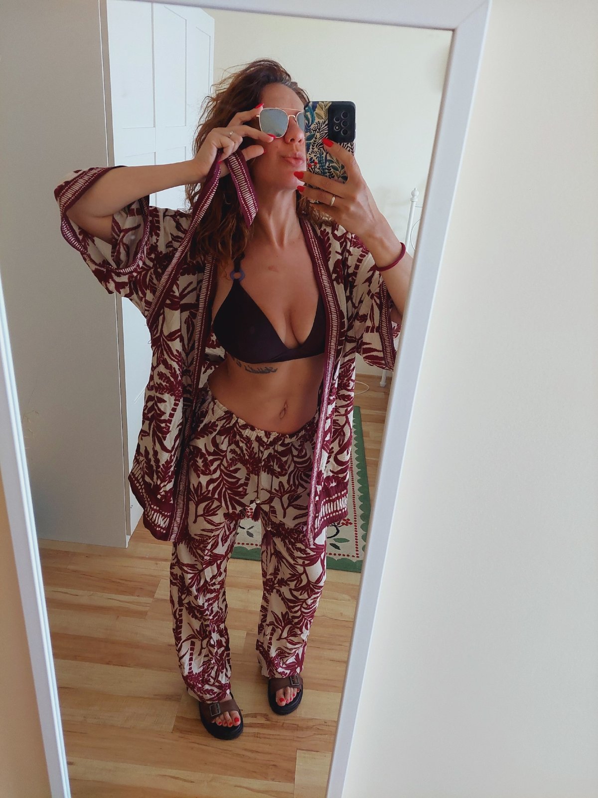 Mirror selfies in a Sozopol bedroom, coordinated vacation outfit