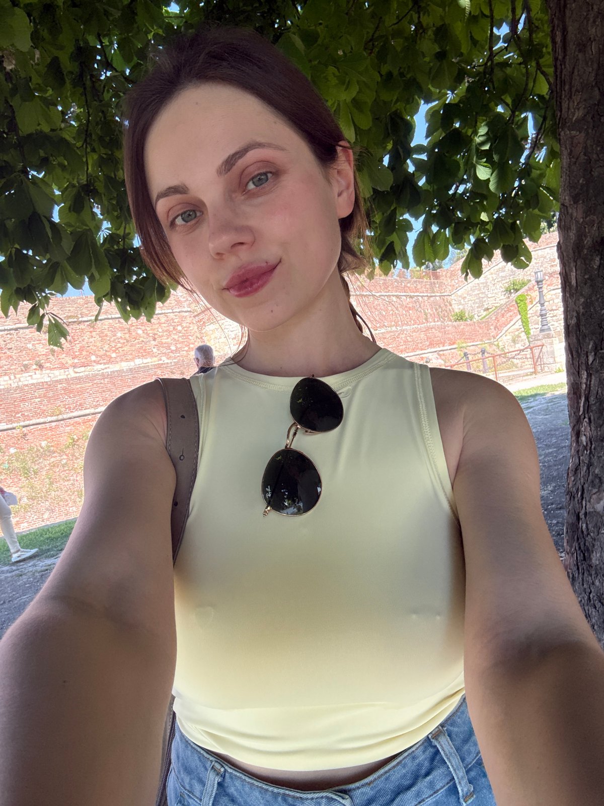 Woman takes selfie near brick structure in Belgrade