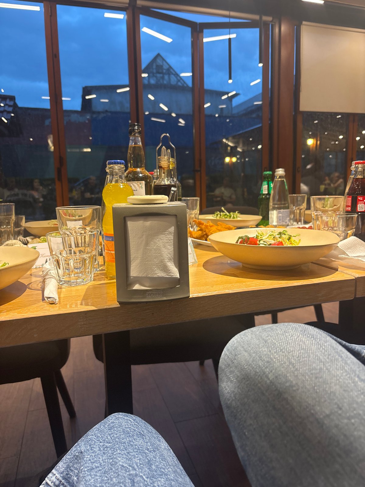 Diner observed at restaurant table wearing blue jeans