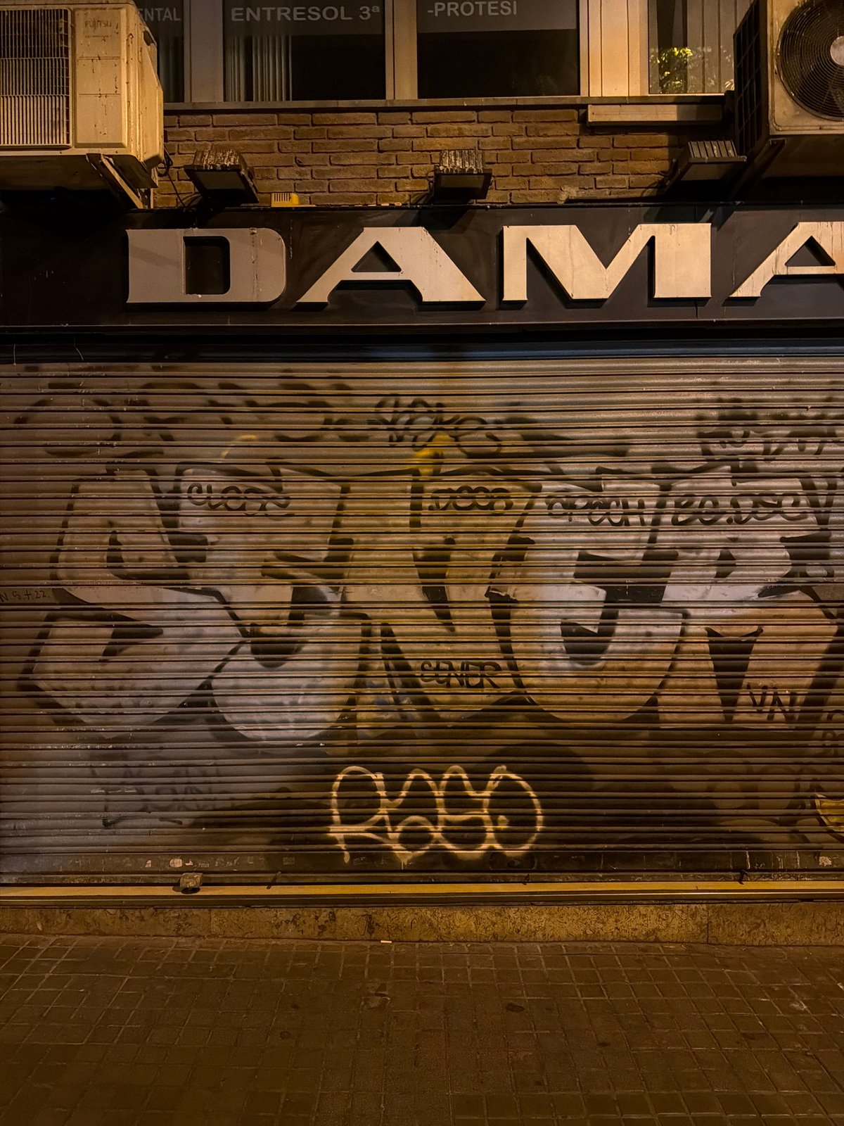 Barcelona's old city at night, monuments lit and most shops shut