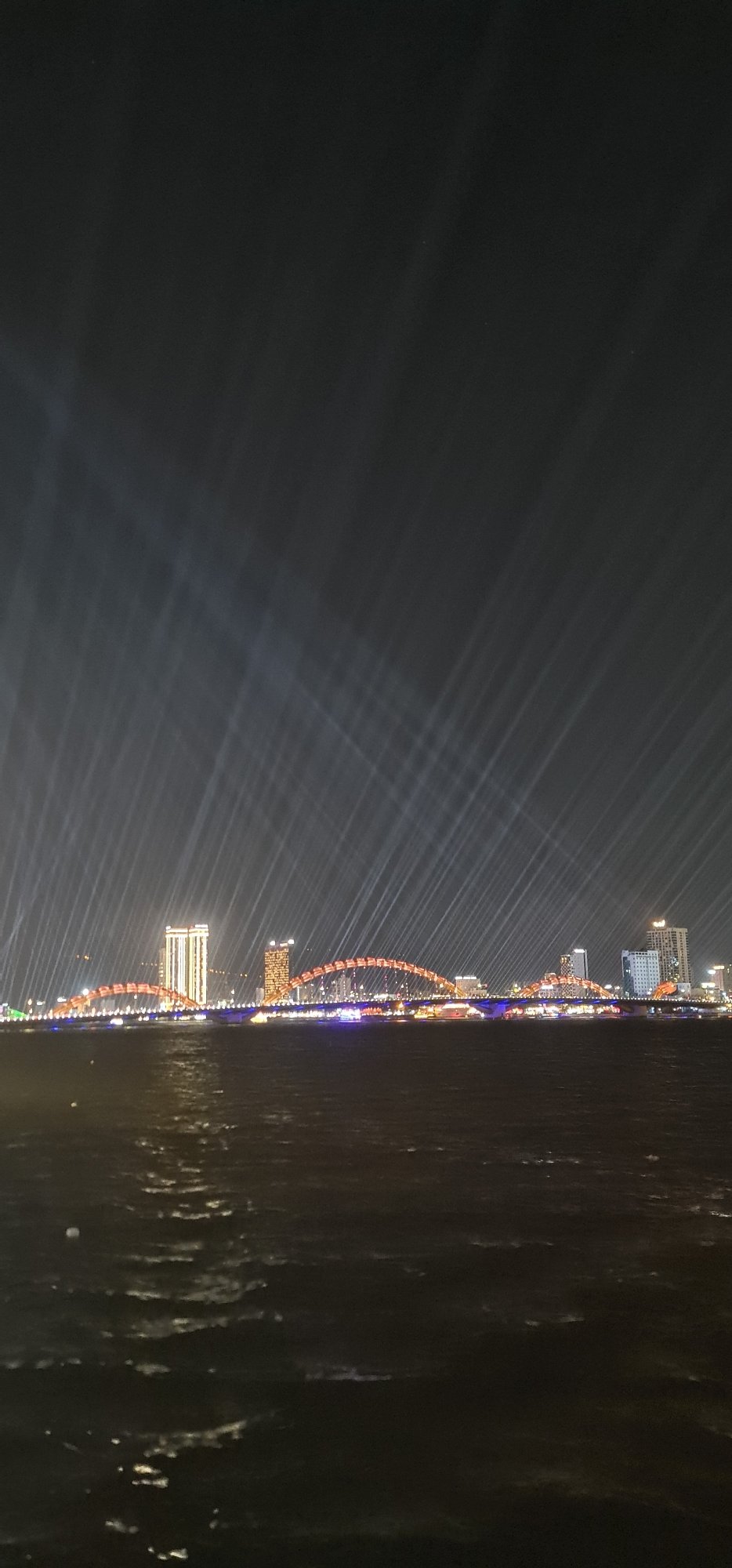 Dragon Bridge illuminated in red and orange in Đà Nẵng