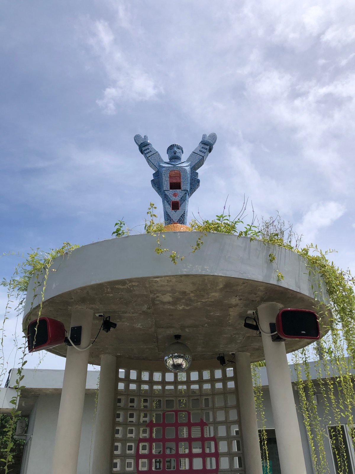 Workers maintain blue robot statue on Sri Lankan rooftop