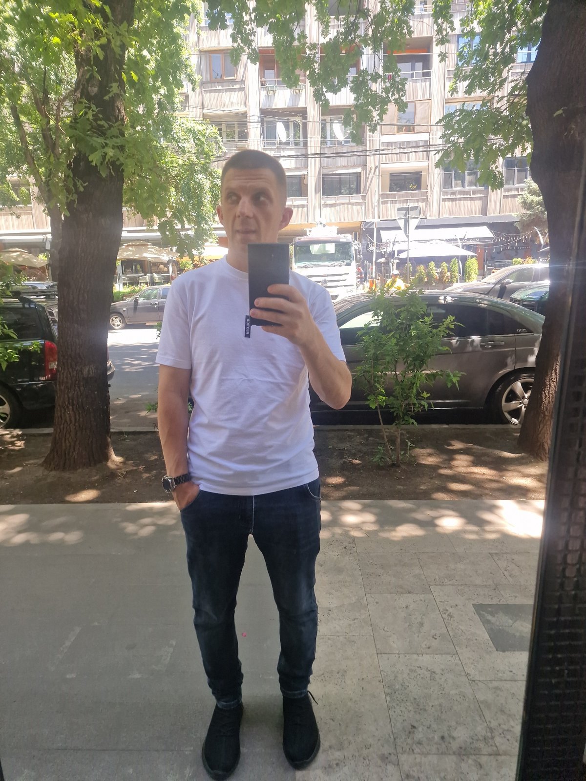 Morning street life in Yerevan, with cars, cafés, and strays