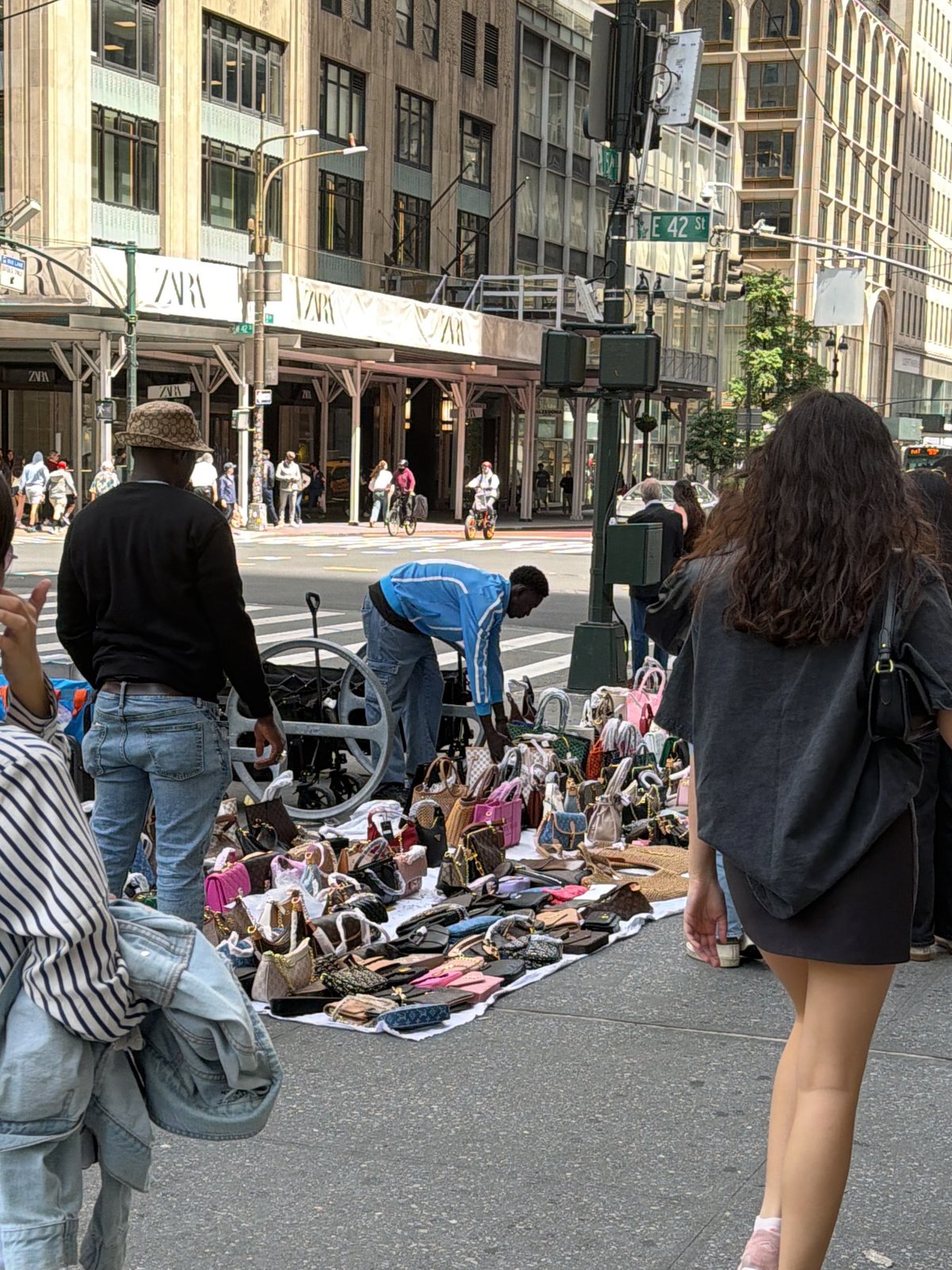 Street vendor sells handbags on East 42nd Street corner