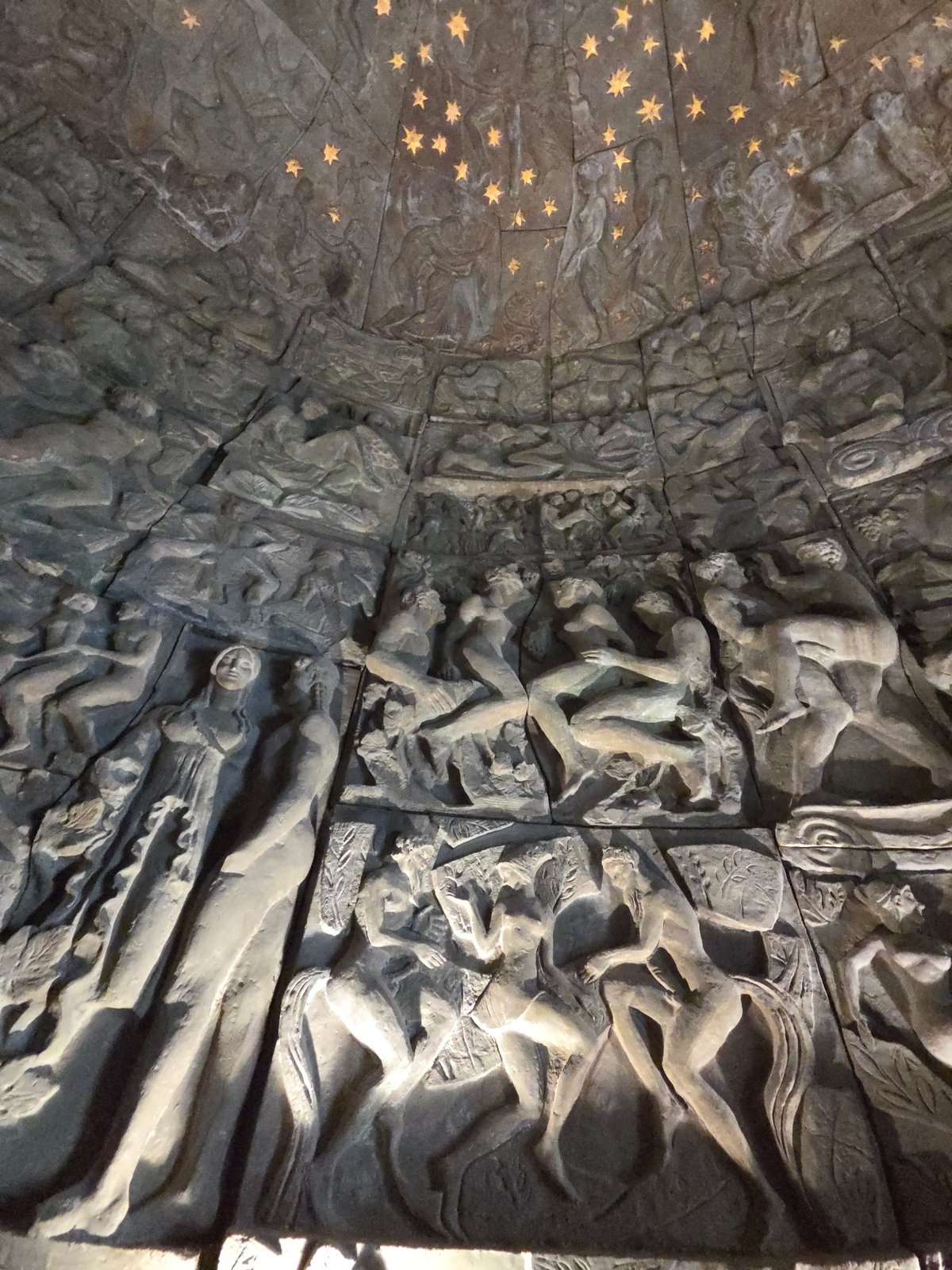 Tourist documents stone carvings at Santiago de Compostela memorial wall