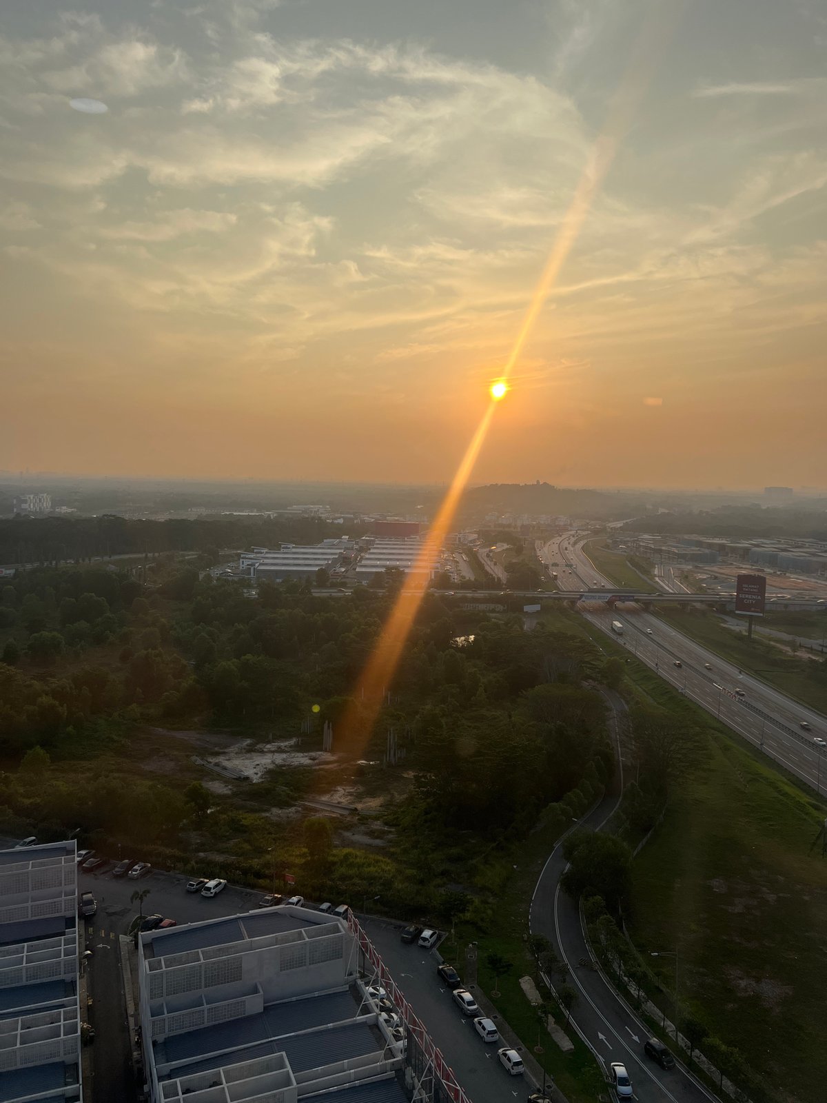 Golden sunrise illuminates Sepang residential landscape from elevated viewpoint