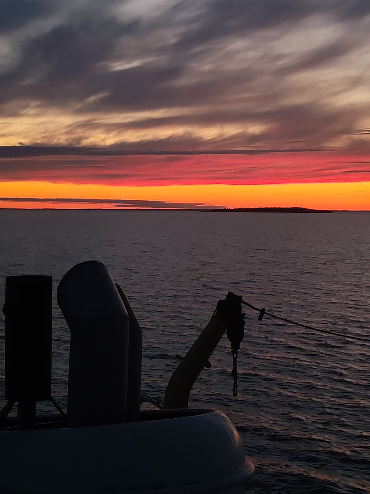 Dramatic sunset observed from vessel deck in Russian waters