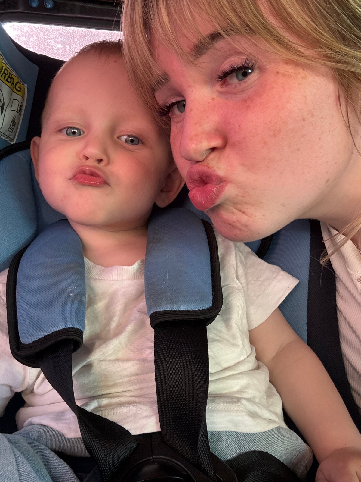 Mother and child share playful moment in Chaikovsky car