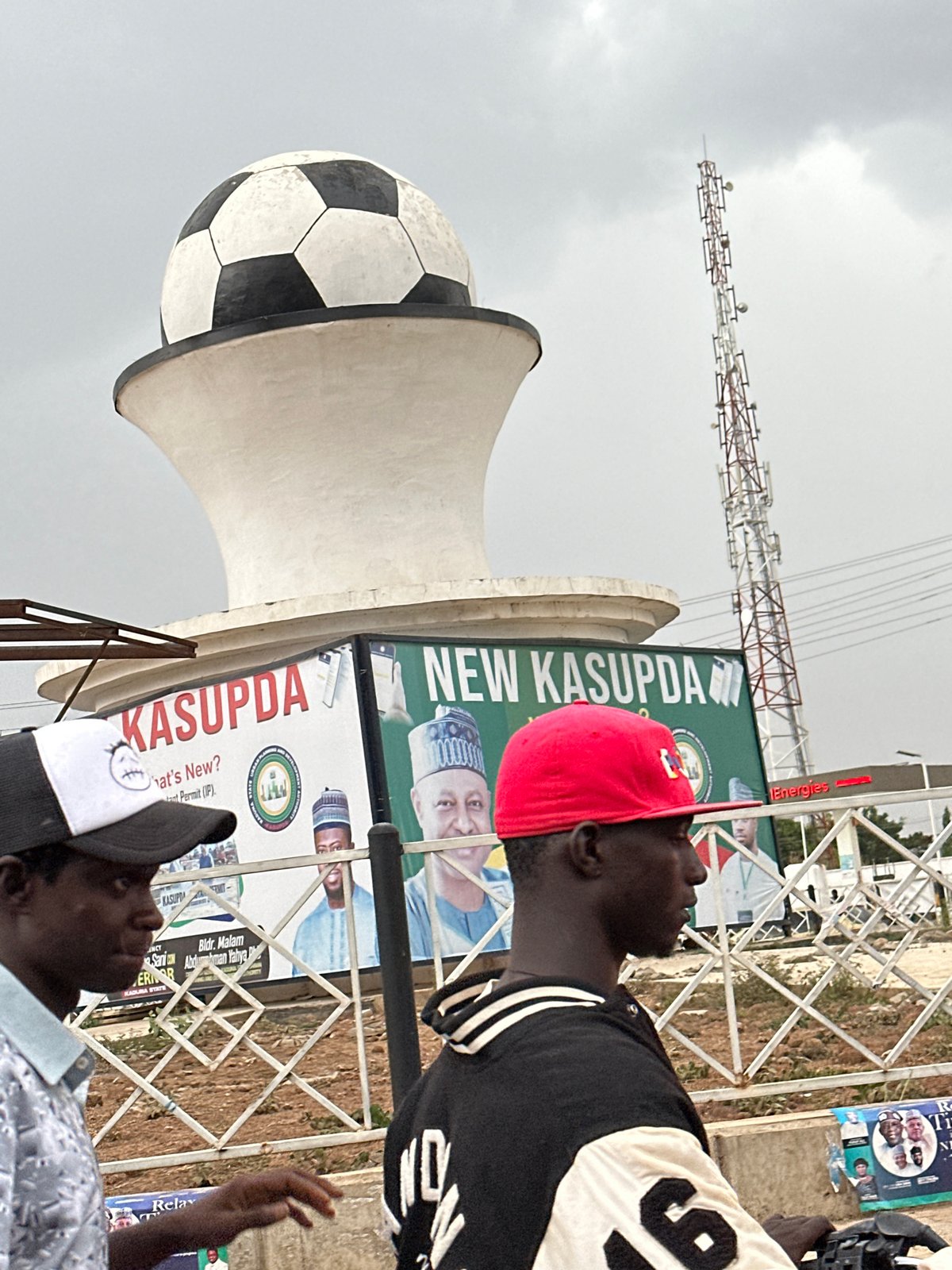 Nigerian market scenes with locals, football sculpture documented