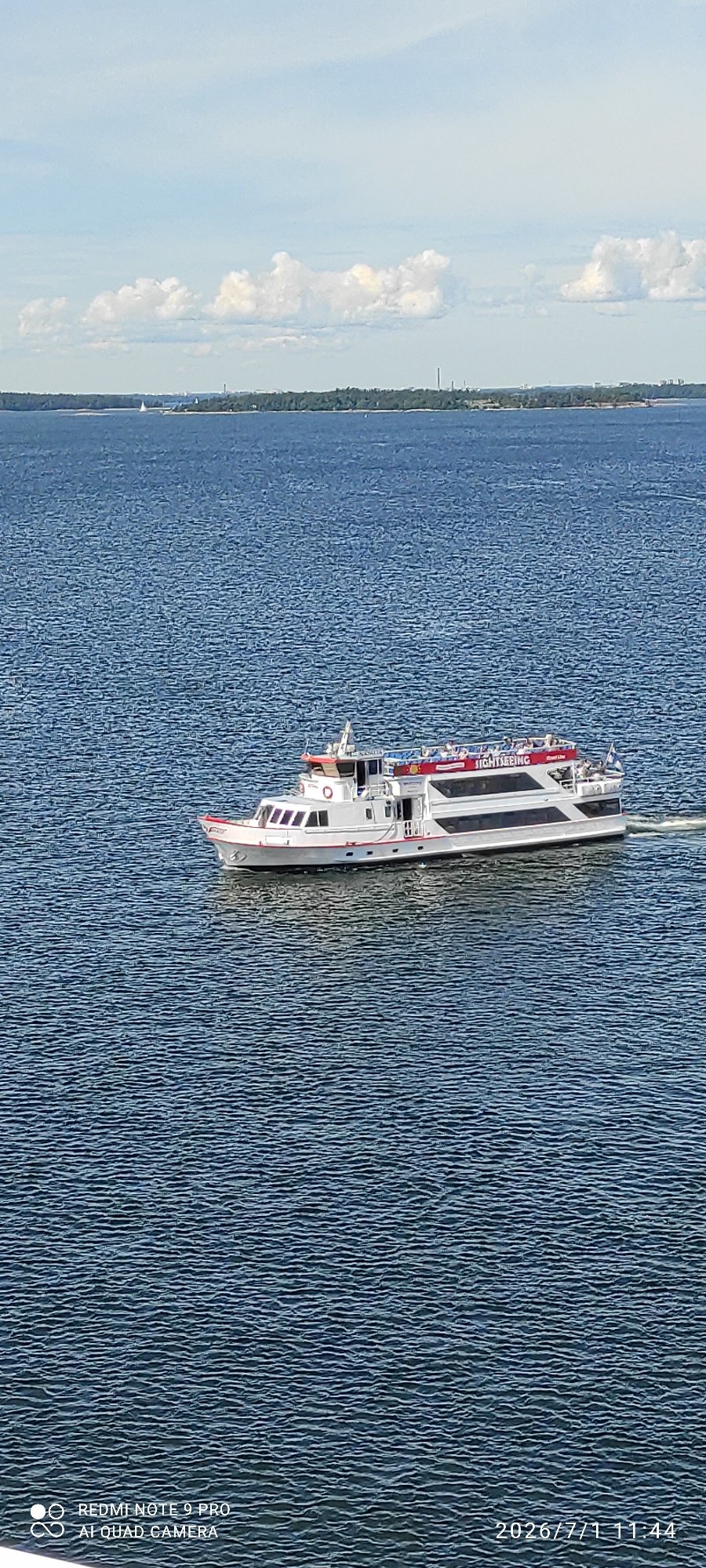 Ferry and sightseeing boat navigate Helsinki's coastal waters