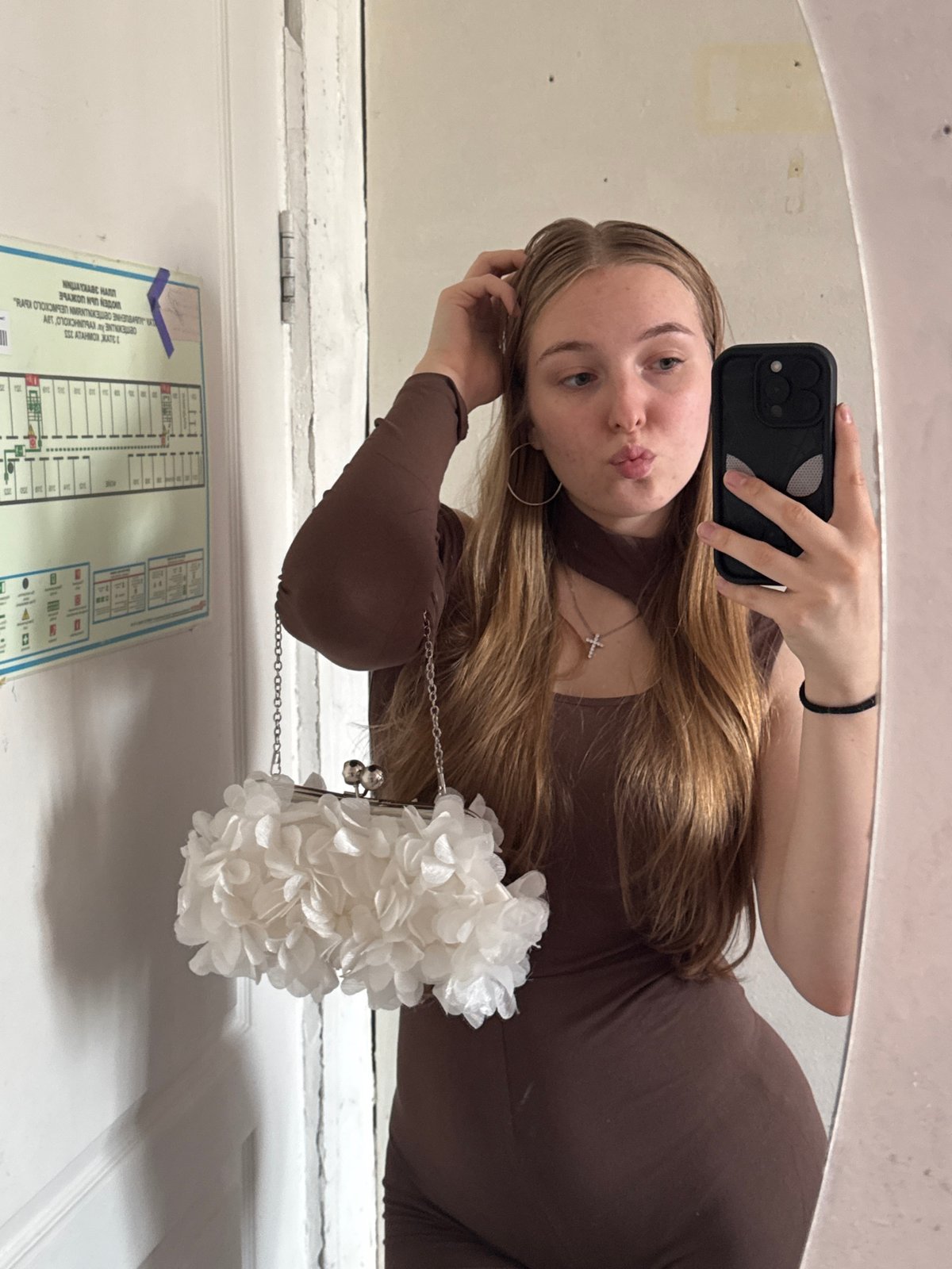 Woman takes mirror selfies in brown outfit in Perm