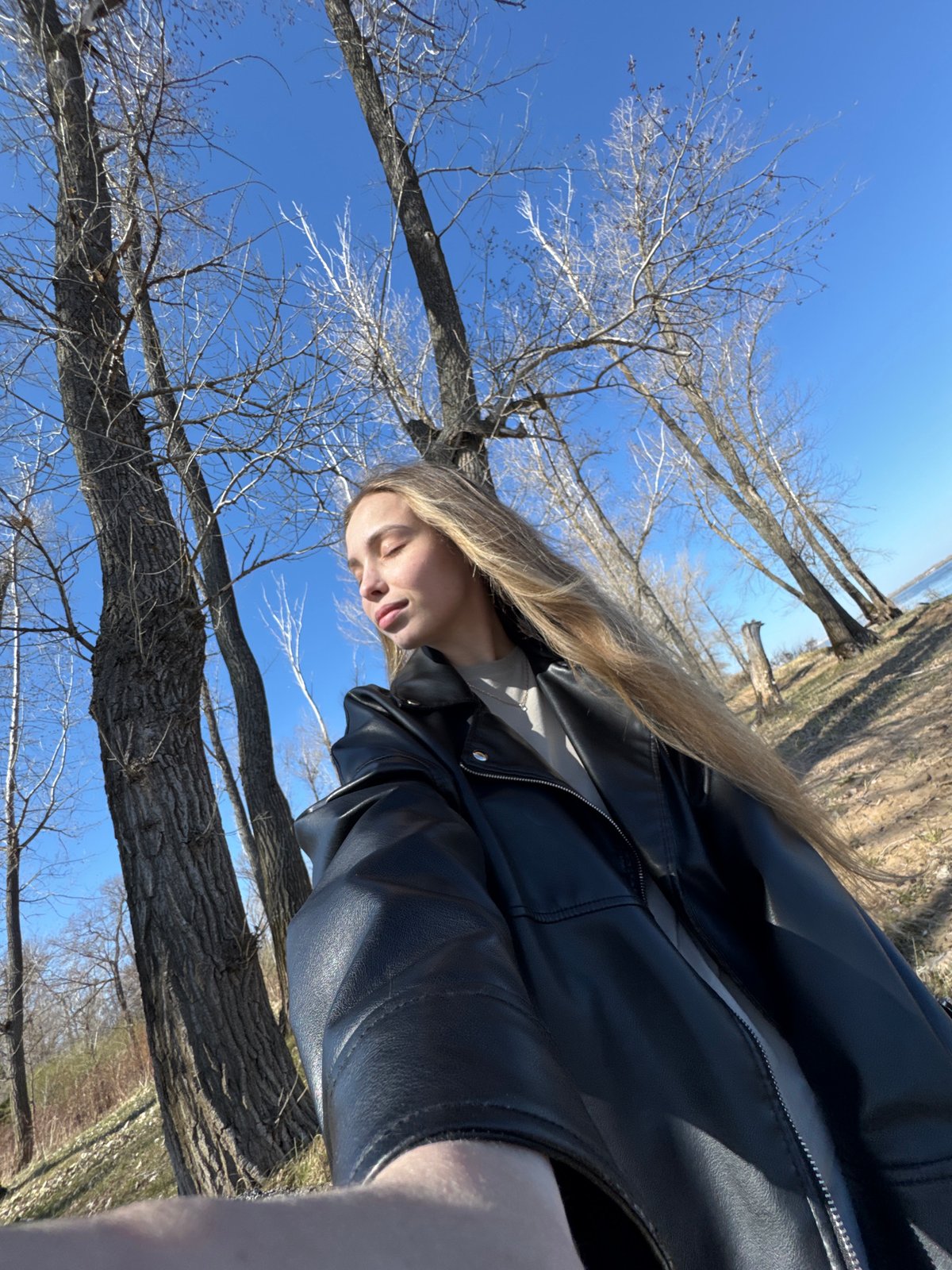 Woman in leather jacket photographed near Russian waterway