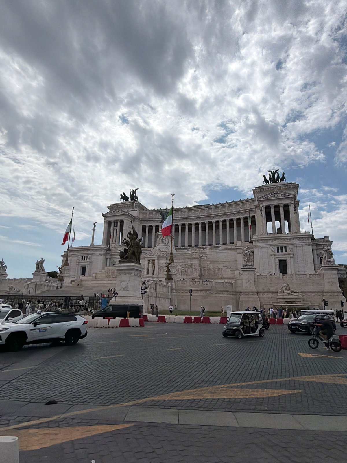 Tourist documents Rome's historic monuments during morning walking tour