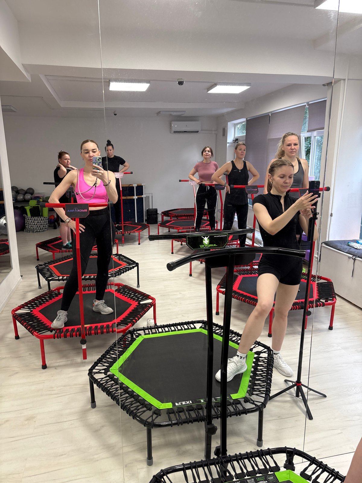 Trampoline fitness class in a Russian gym, rainy day outside