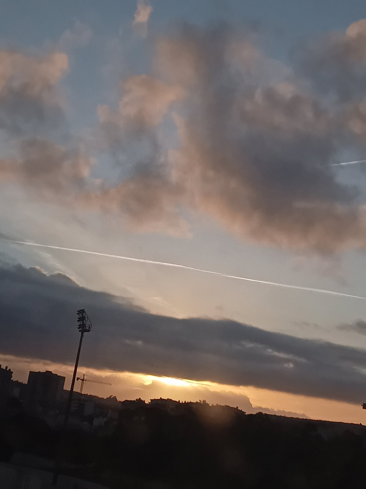 Urban dawn captured from elevated position, dramatic skies observed