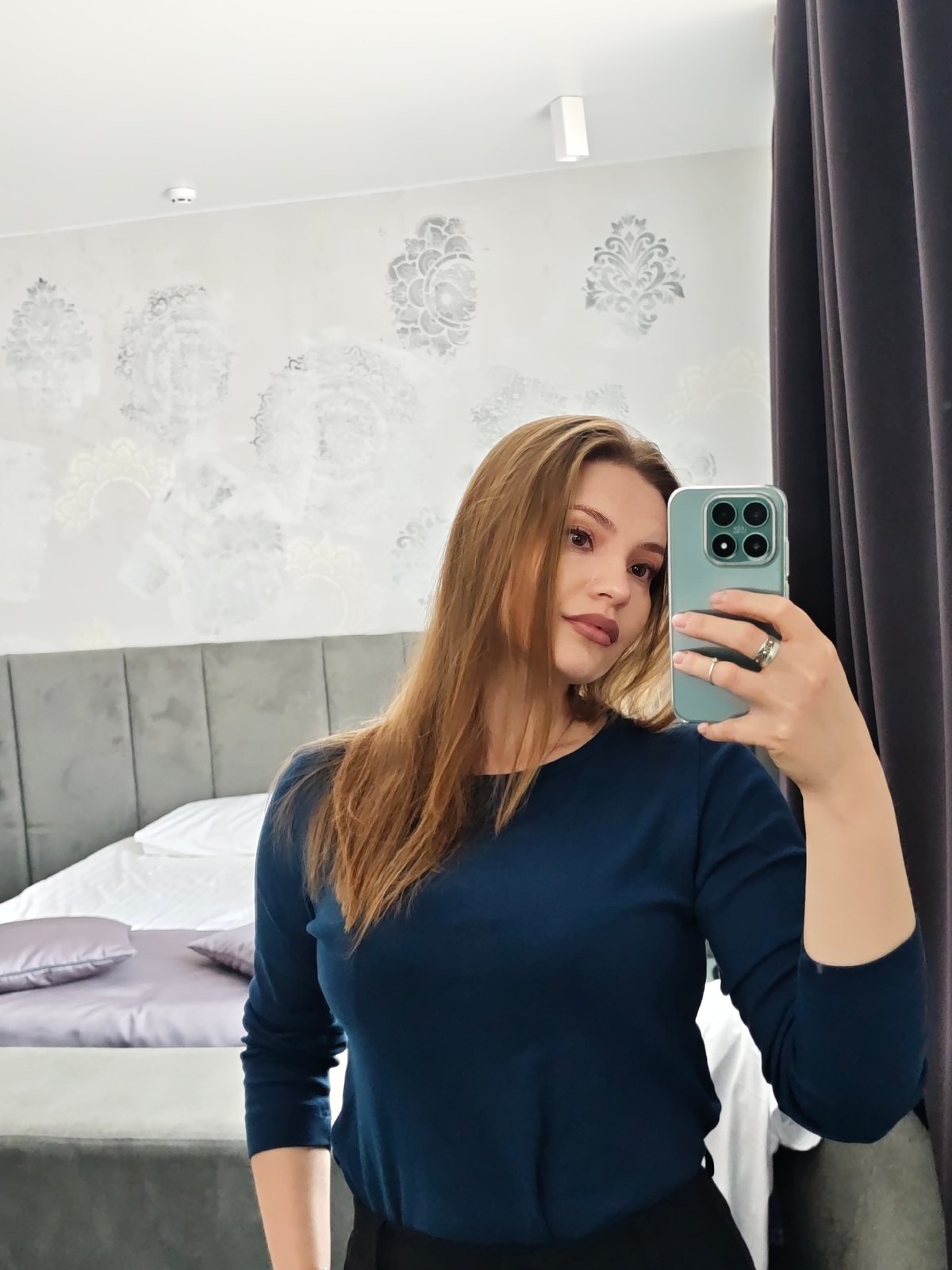 Woman takes mirror selfies in Chernivtsi bedroom