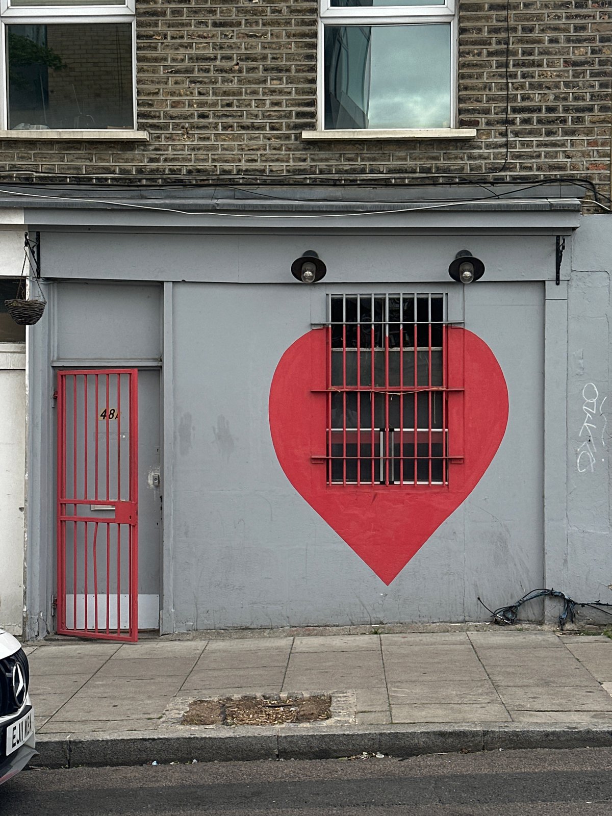 Red heart street art spotted on London building wall