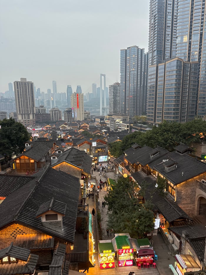 Evening crowds navigate illuminated streets in Chongqing's Yuzhong District