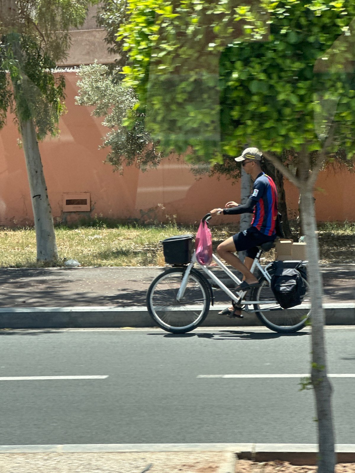 Cyclist spotted on Marrakesh street near fortified wall