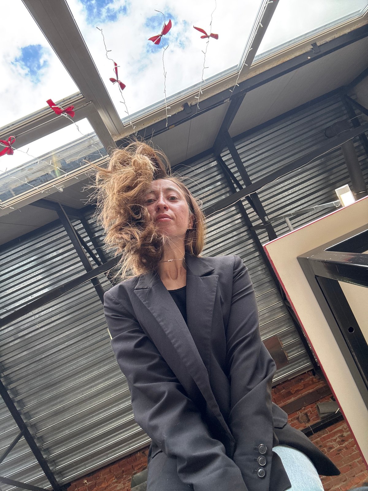 Woman photographed from low angles in Chaikovsky cafe interior