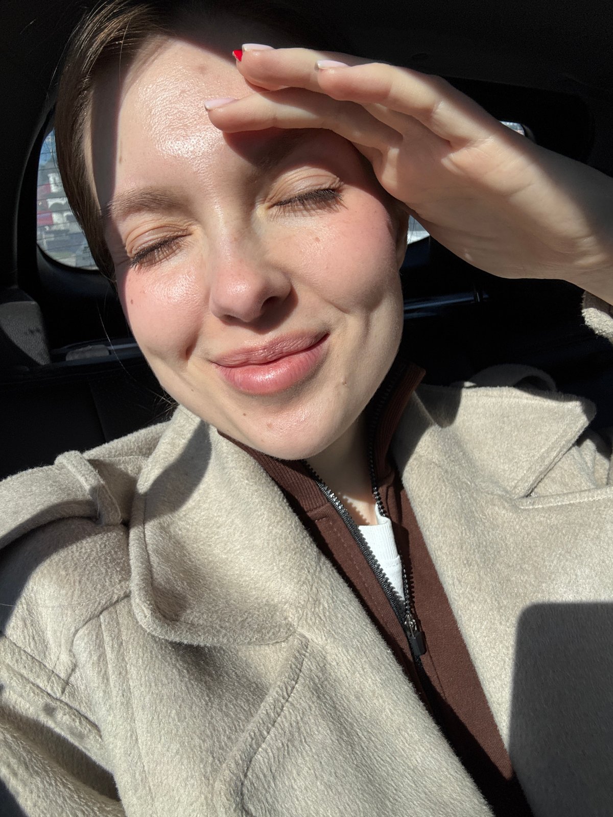 Woman shields eyes from morning sun in Moscow