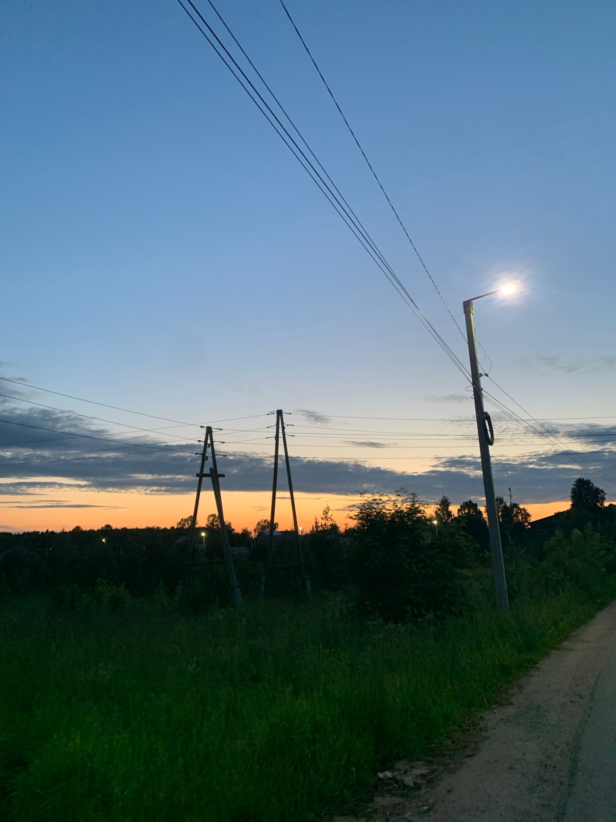 Dusk settles over a rural road in Ganino, Russia