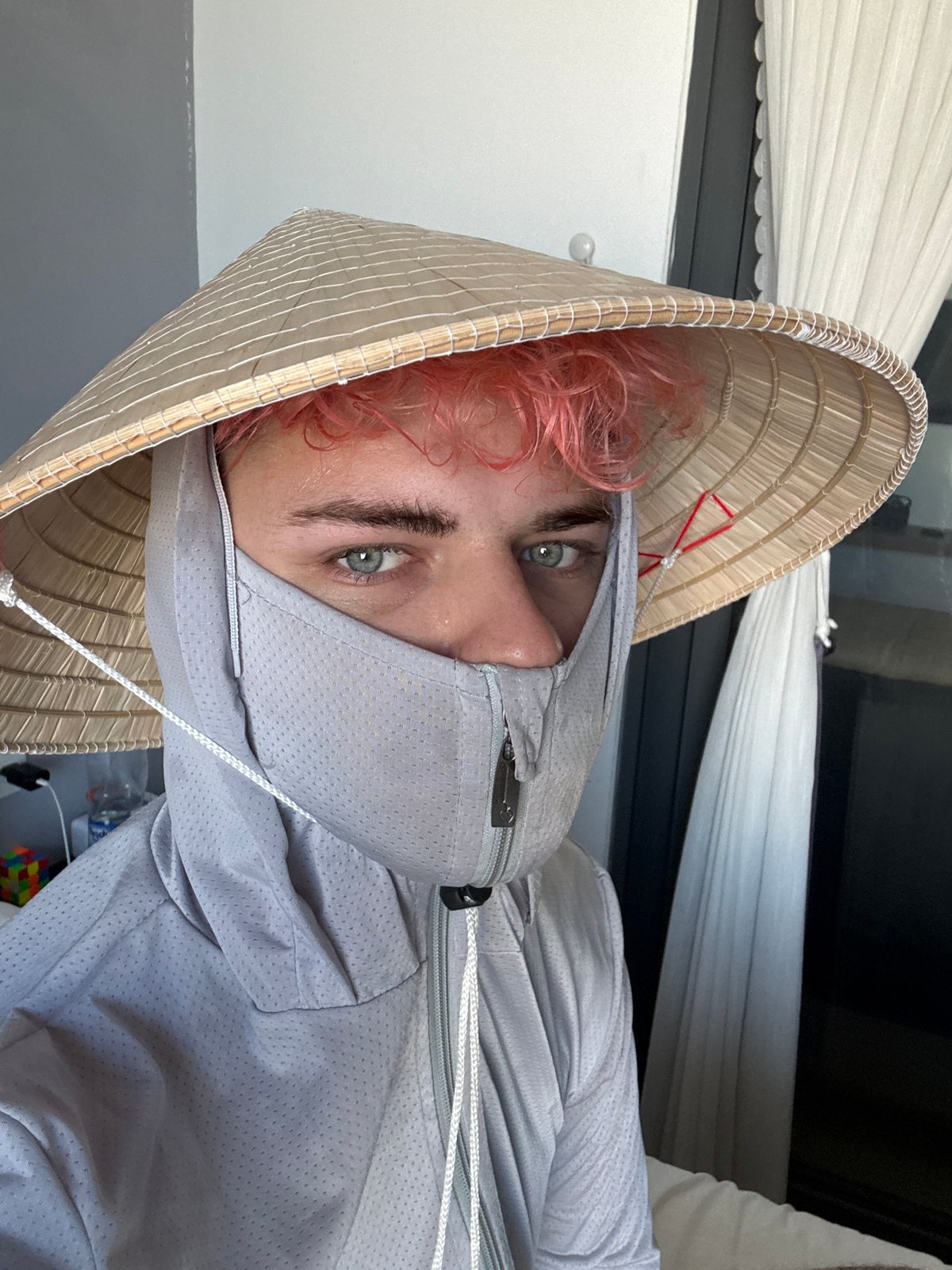 Pink-haired person photographed in Vietnamese conical hat in Đà Nẵng