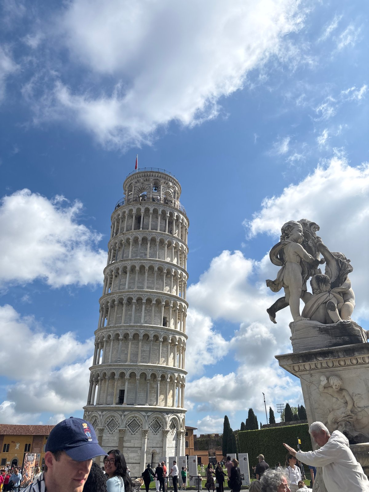 Tourist photographs capture Leaning Tower of Pisa under cloudy skies